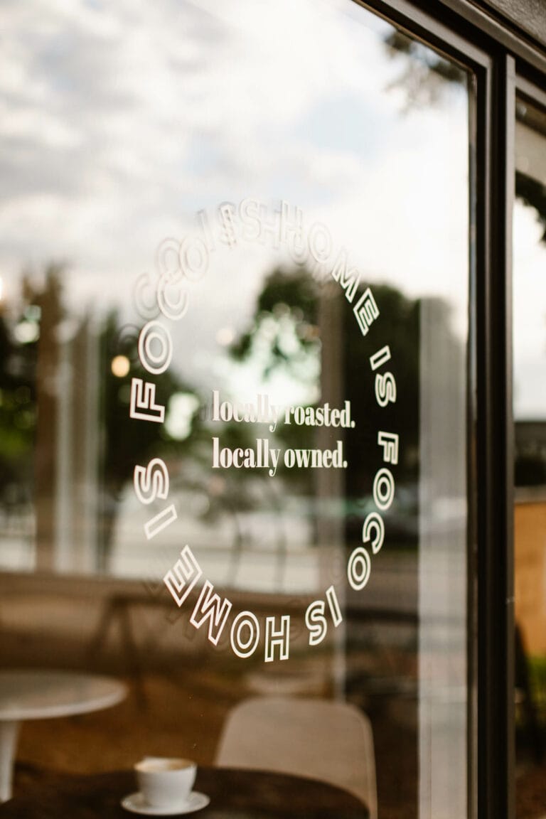 a sign on the window at Lima Coffee Roasters Fort Collins that says "FoCo is Home"