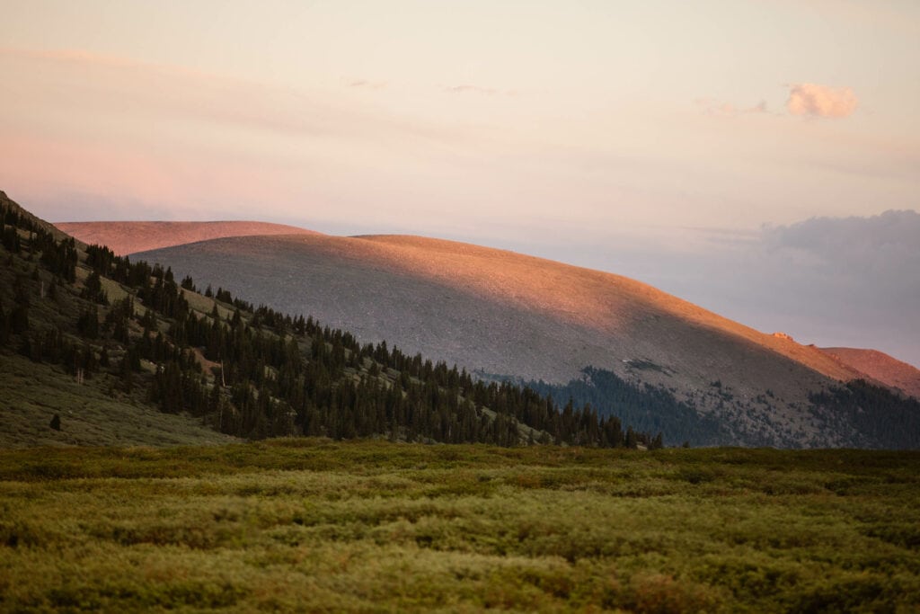 alpenglow on rolling hills above tree line on Guanella Pass Scenic Byway